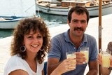 Example: a small 1984 close-up of a woman and a man at a harbour café