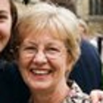 The small original: a smiling mother in her sixties with glasses, at a graduation