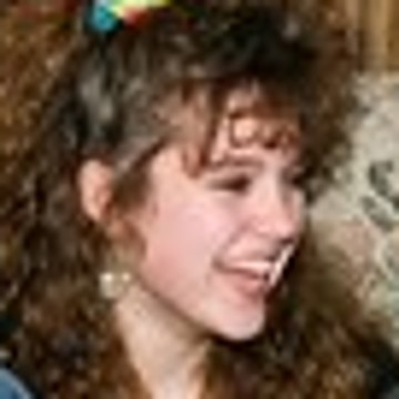 The small original: a laughing teenage girl with curly hair and a scrunchie